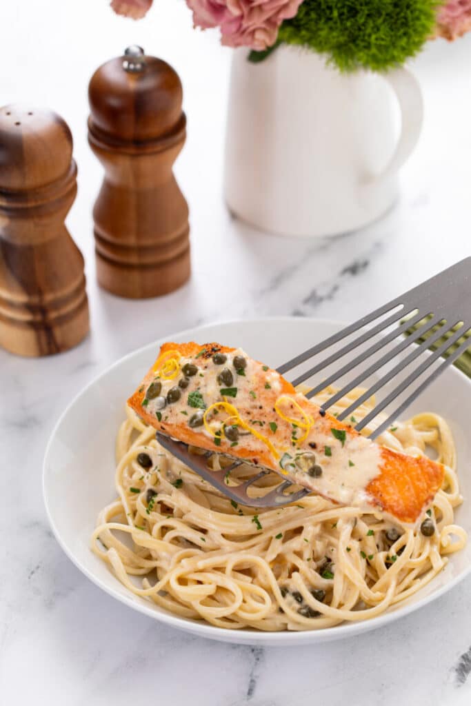 Creamy Lemon Salmon Piccata Pasta with topped salmon