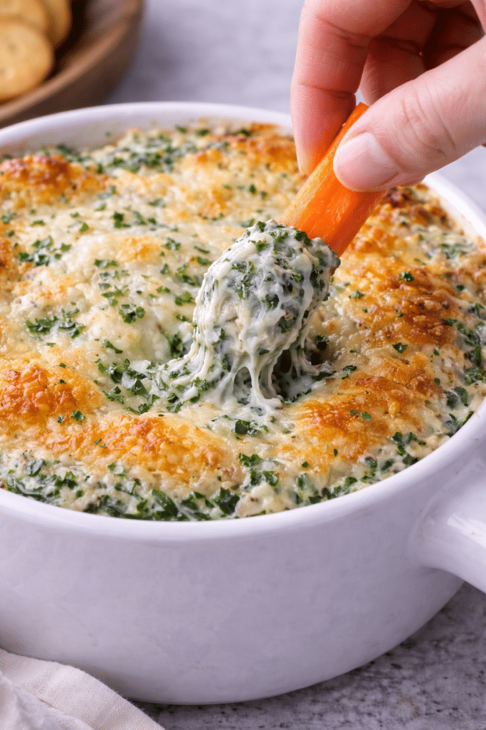 carrots dipping in creamy spinach dip
