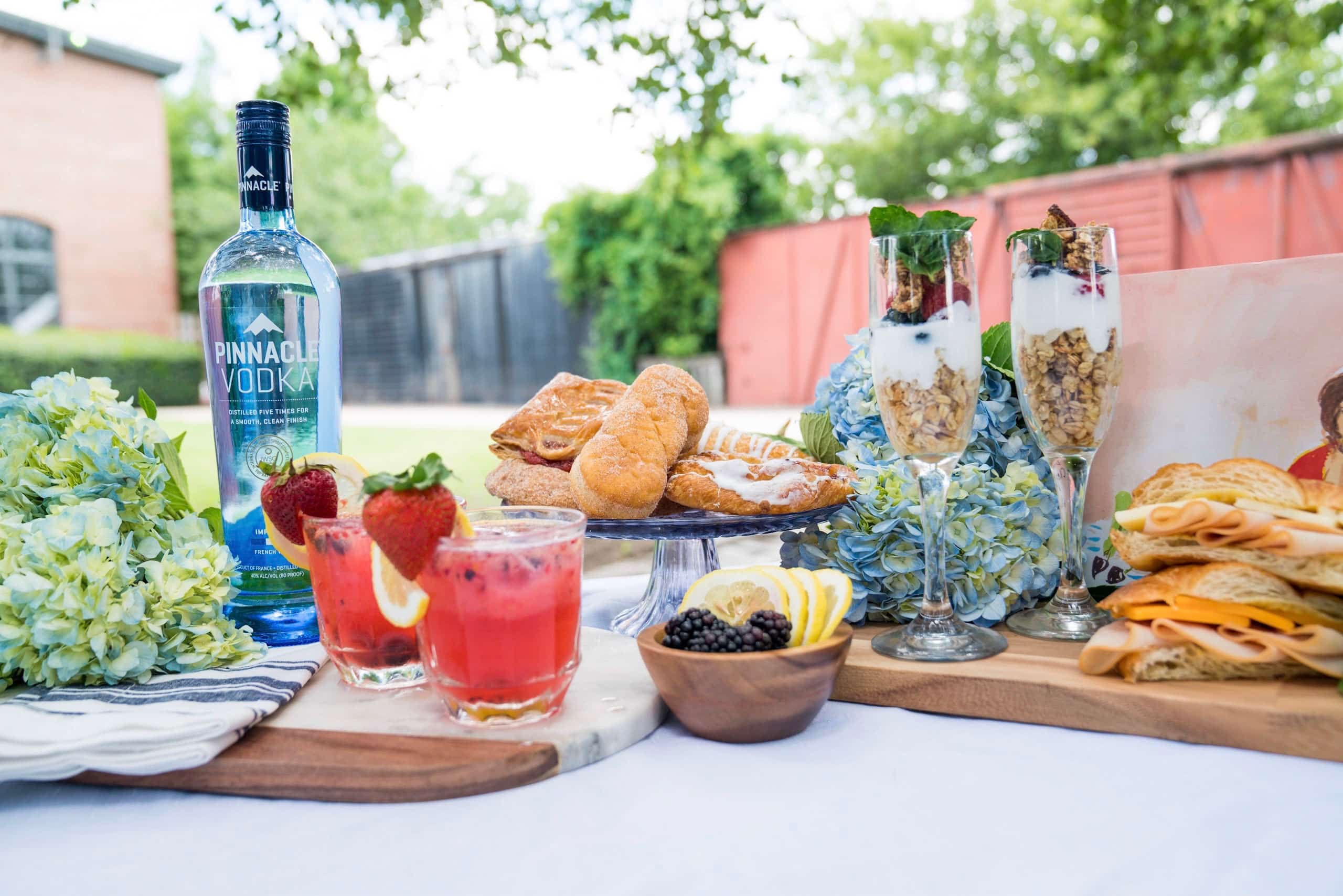 French brunch table with croissants fresh fruit champagne and elegant place settings image