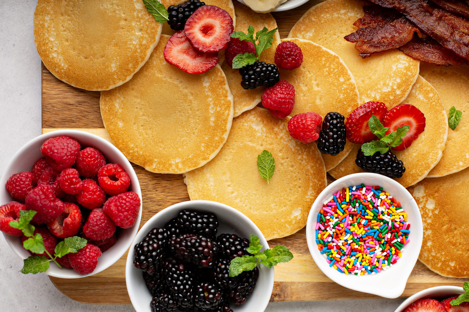 Pancake platter with raspberries, blackberries, sprinkles and mint