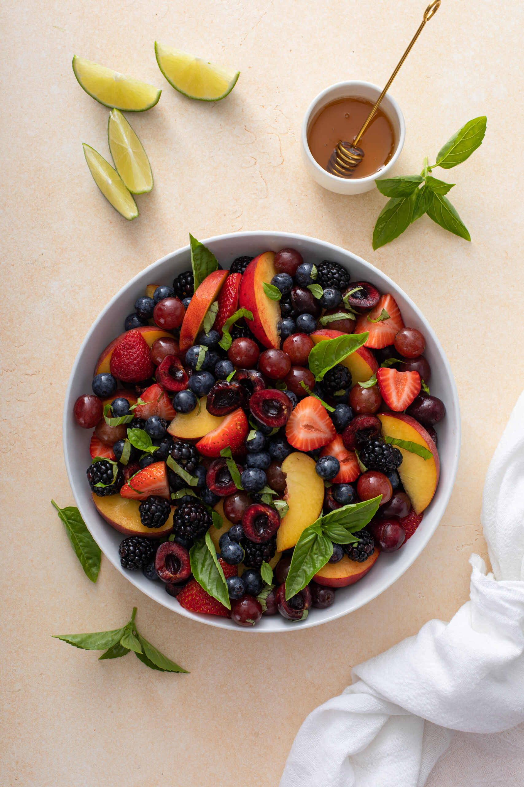 Hands down the perfect summertime peach fruit salad that will be a hit at any summer soiree this year! Curious how to make this Honey Lime Basil Peach Fruit Salad? CLICK HERE for the recipe!
