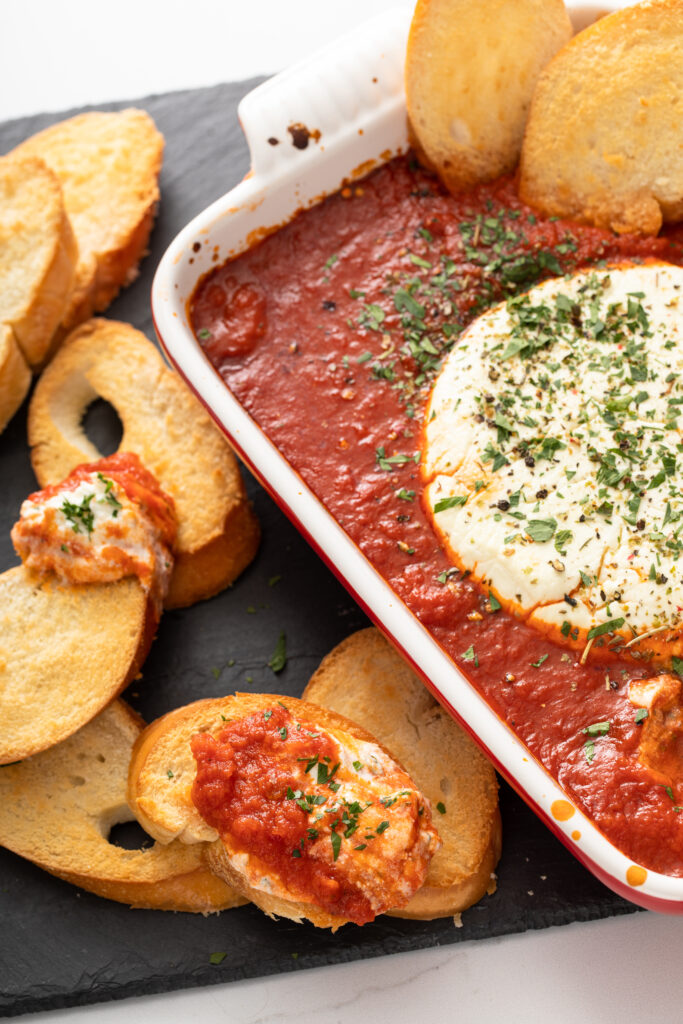 Looking for the perfect restaurant inspired dip? You need to try this Easy Baked Goat Cheese Dip recipe ASAP this holiday season! 
