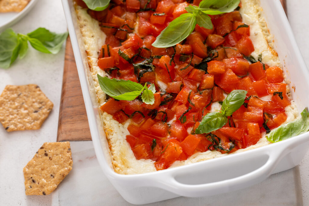 Craving a delicious appetizer? Baked Goat Cheese Bruschetta Dip with Crackers offers a creamy, cheesy bite with tangy tomatoes and crispy crackers—ideal for parties or a savory snack.