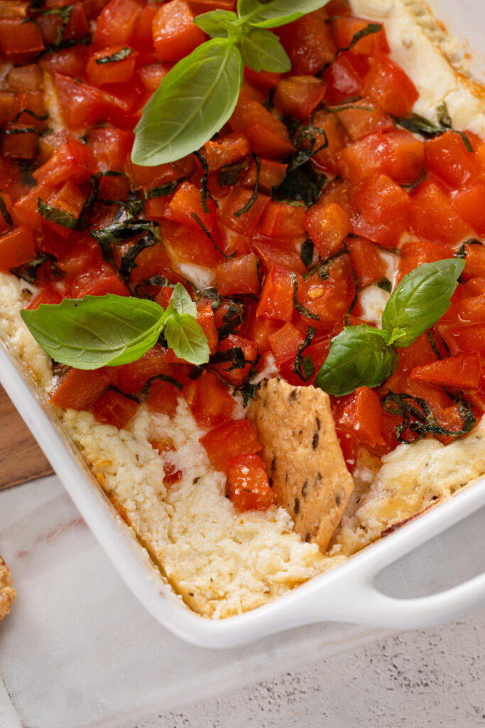 Craving a delicious appetizer? Baked Goat Cheese Bruschetta Dip with Crackers offers a creamy, cheesy bite with tangy tomatoes and crispy crackers—ideal for parties or a savory snack.