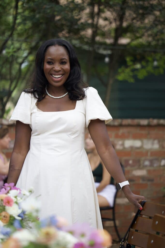 Erica A. Thomas in white dress
