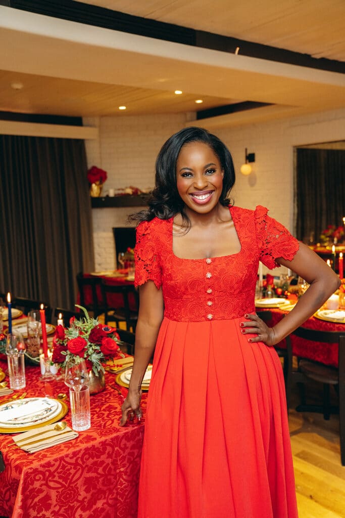 Erica Thomas standing in the room for her holiday ornament exchange party