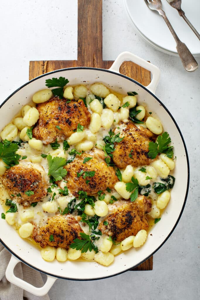 Baked Chicken Gnocchi with Garlic Parmesan Cream Sauce in white sauce pan