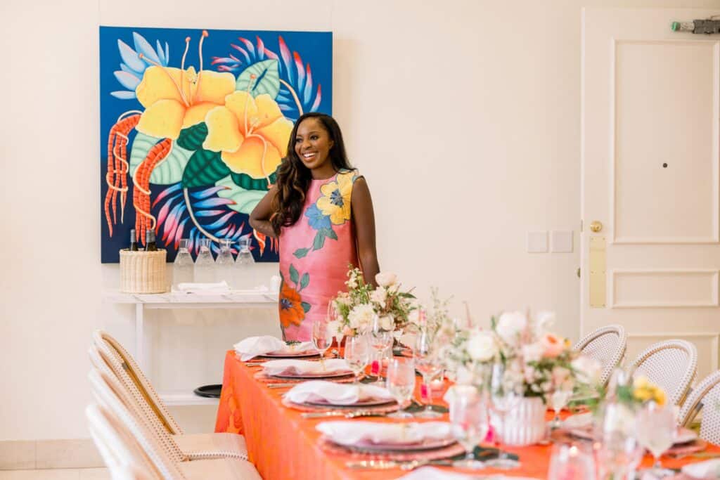 Erics with a flower painting at her back