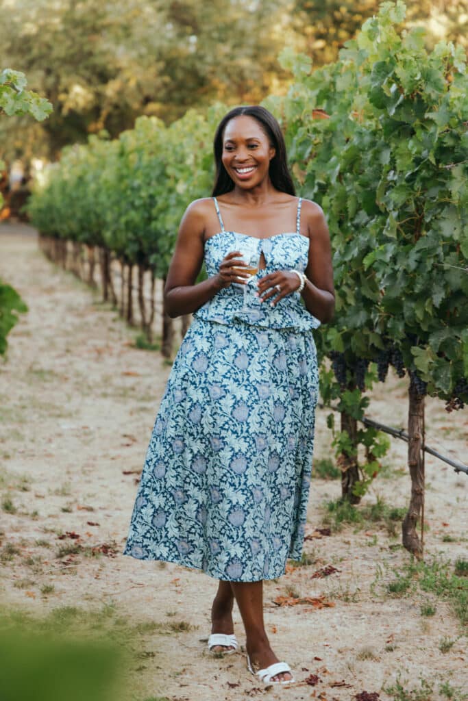 Erica A. Thomas weating floral blue dress