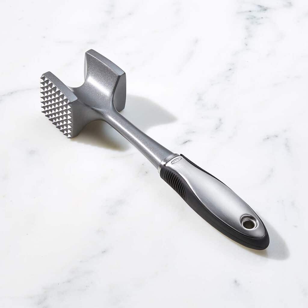 Meat tenderizer mallet with raw steak