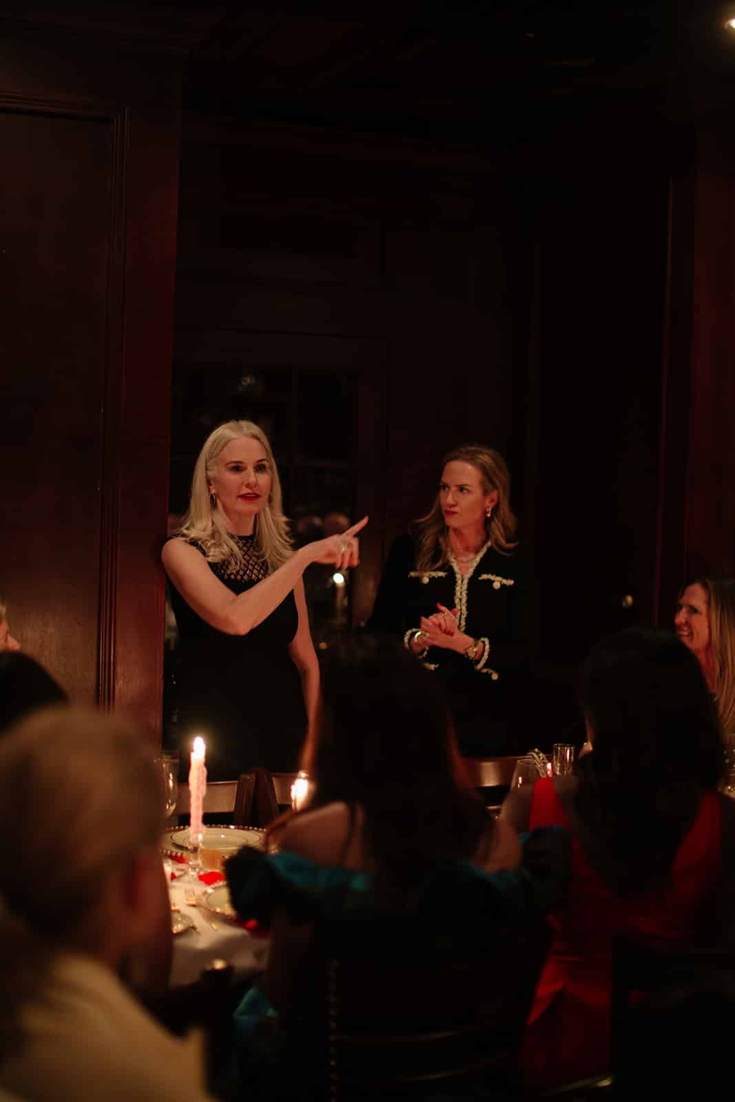 Erica sharing a story with guests as the Galentine's dinner conversation unfolds