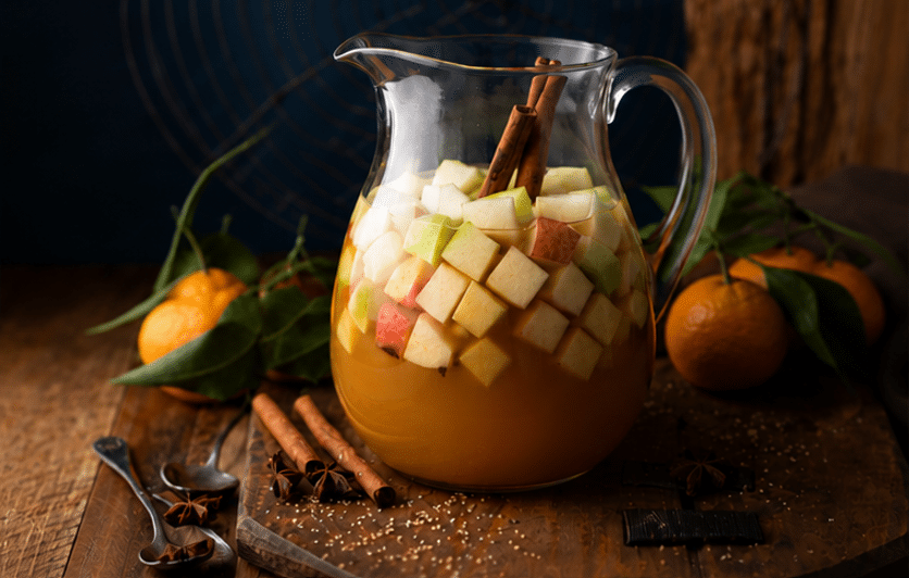 Easy Fall Apple Pie Sangria Cocktail ingredients mized together in a transparent pitcher