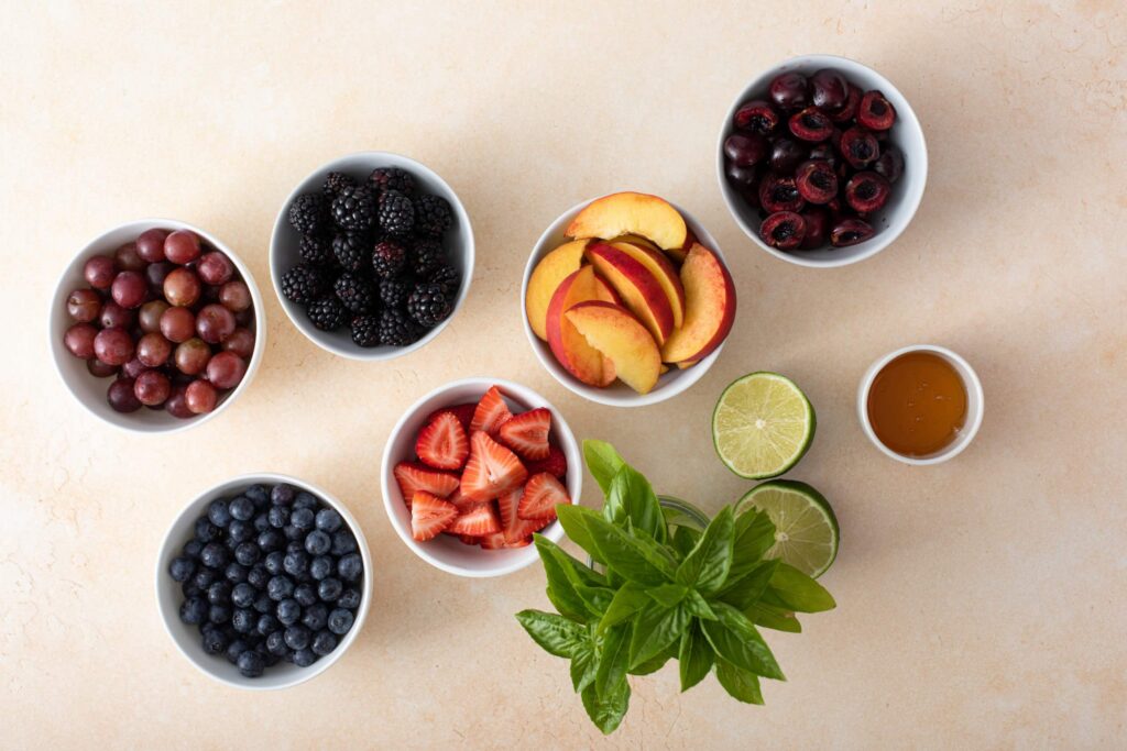Ingredients of Honey Basil Peach Fruit Salad flat lay shot
