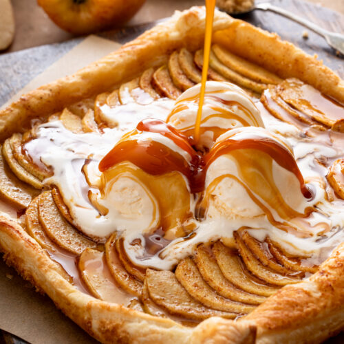 Close-up of a slice of apple galette with melting ice cream