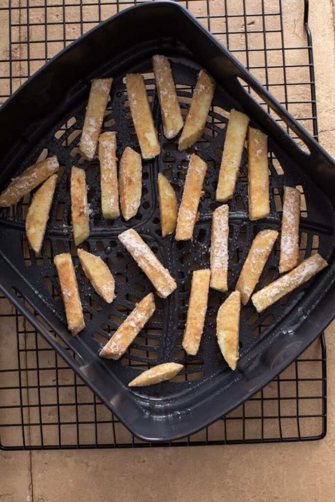 Air Fryer Apple Fries with Caramel Cream Dip spread on the air fryer