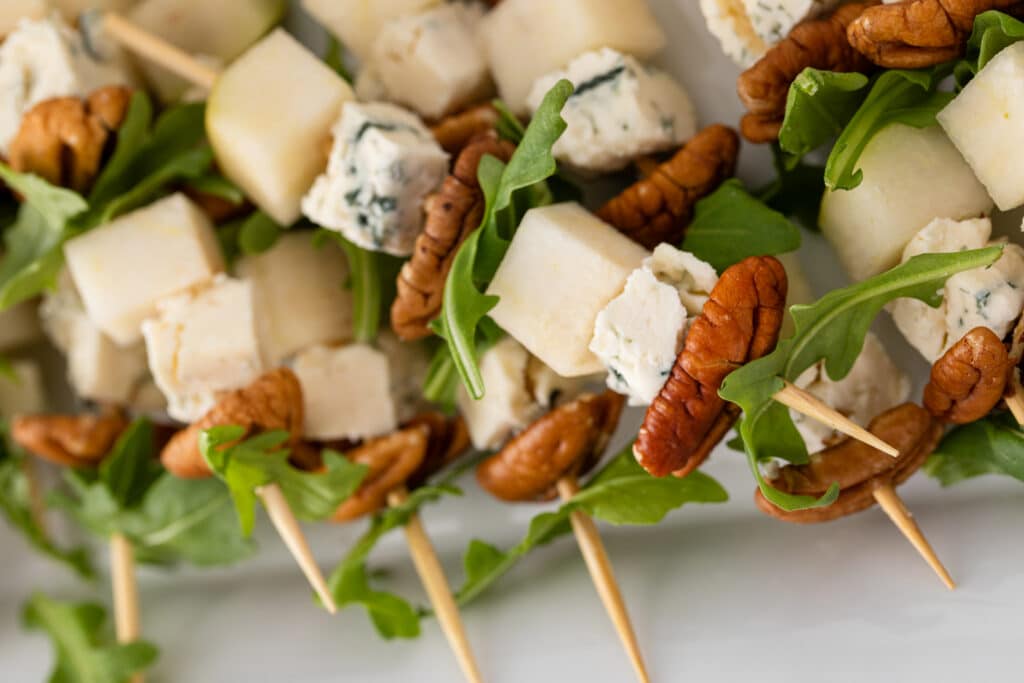 Close up shot Pear and Bleu Cheese Appetizer Skewers with Arugula and Pecans