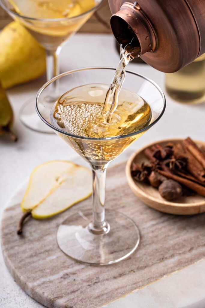 Straining the peartini into a chilled coupe glass