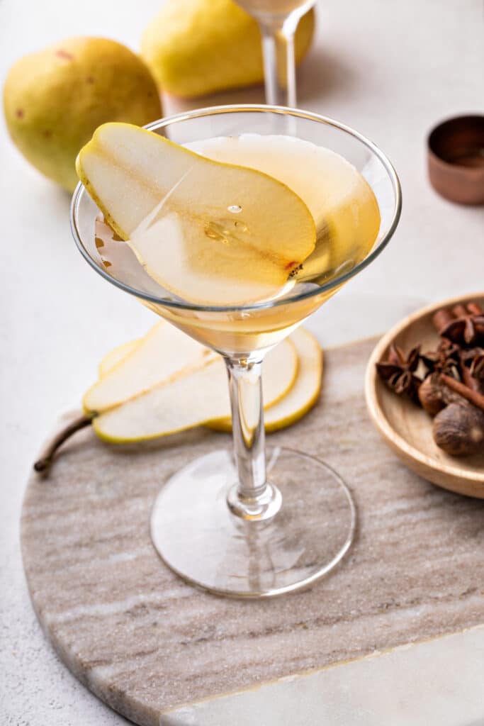 Garnishing the peartini with a fresh pear slice