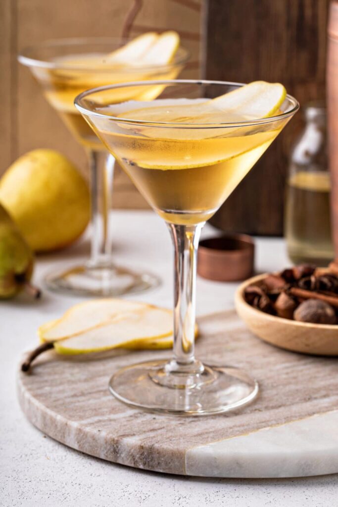 Close-up of a peartini cocktail garnished with a fresh pear slice