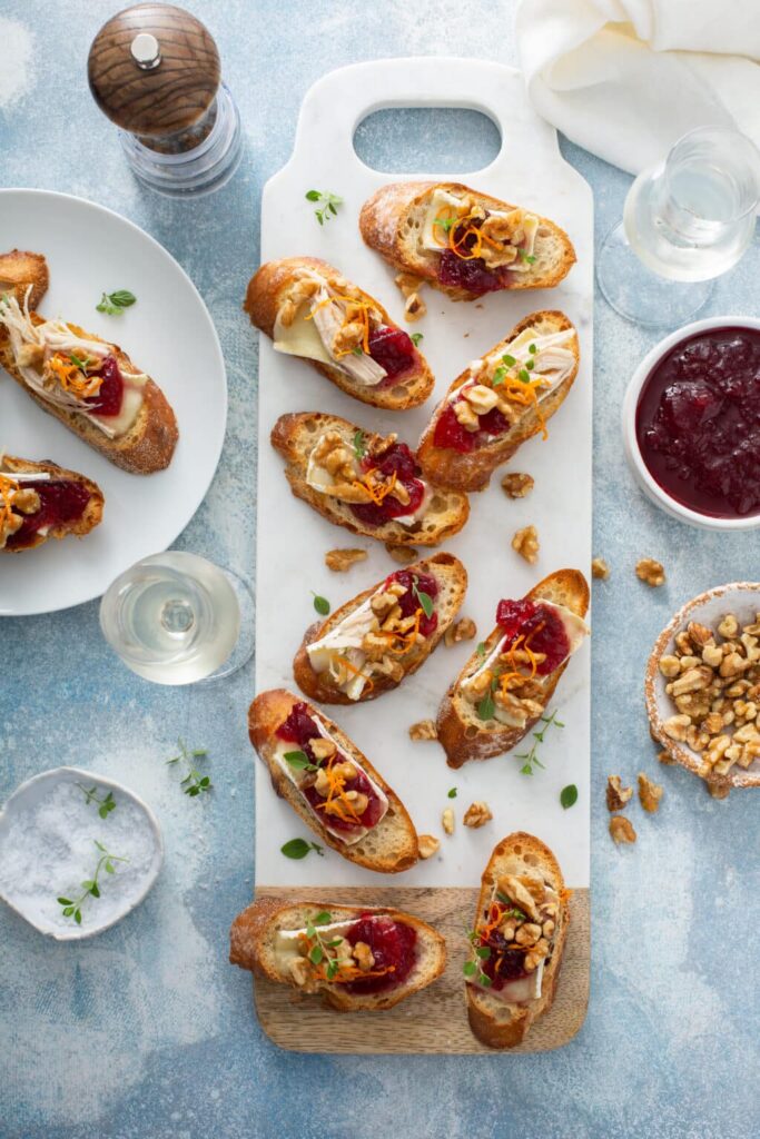 Cranberry brie and walnut crostini served on a festive table