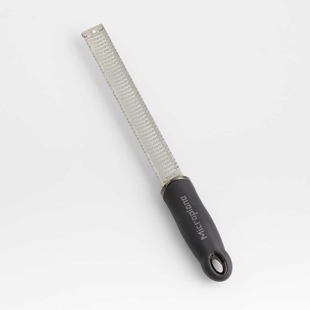 Microplane zester for grating fresh orange zest over crostini