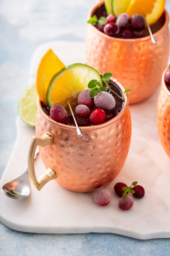 Close-up of cranberry Moscow Mule garnished with fresh cranberries