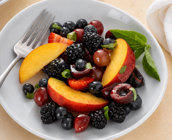 Single serving close up shot of Honey Basil Peach Fruit Salad