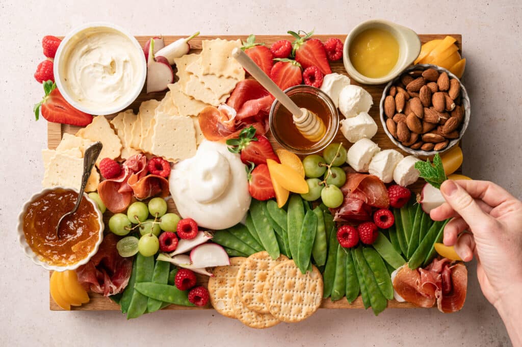 filling the gapswith crackers, nuts and other ingredients of Spring charcuterie board
