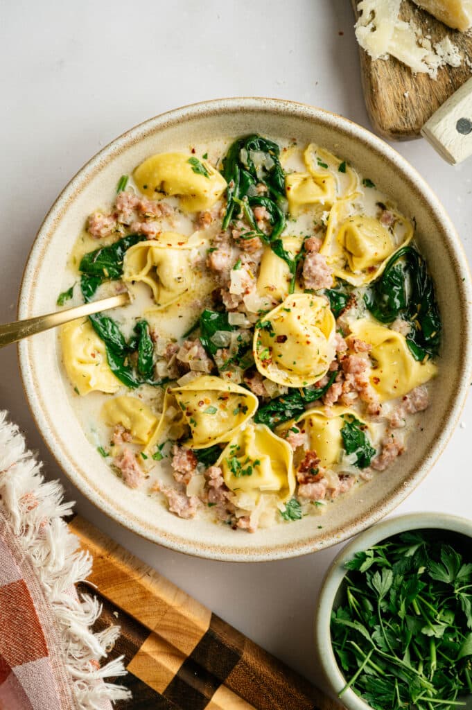 White Sausage tortellini soup on serving plate