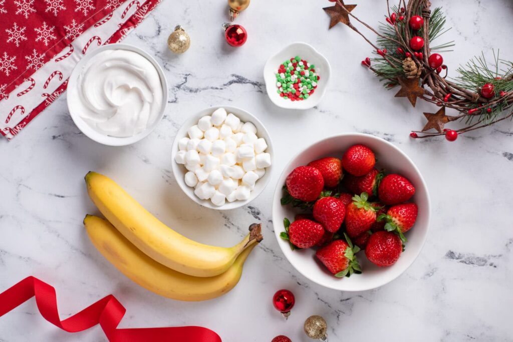 Ingredients for Strawberry Banana Santa Hats flat lay shot