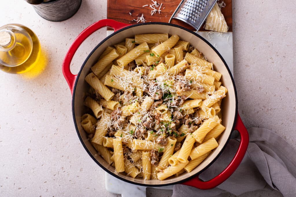 Sausage Rigatoni Pasta with sauce, cheese and sausages in a pan