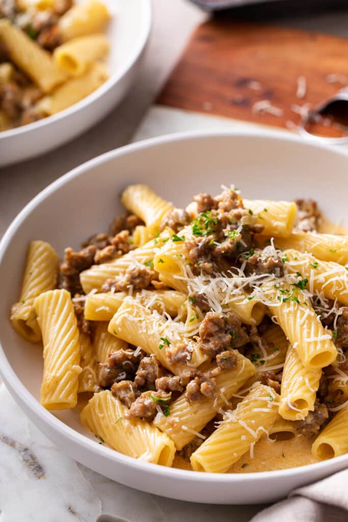 close up shot of Sausage Rigatoni Pasta serve in a white bowl