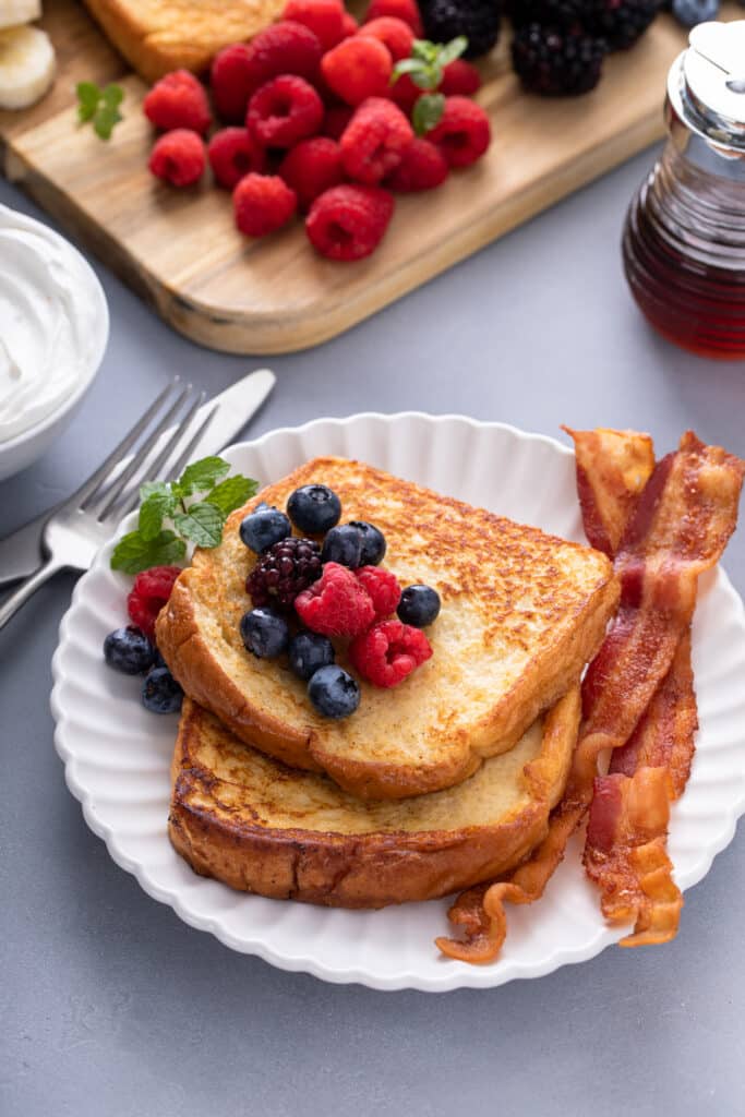 One serving of Easy French Toast Board with syrup, fruits and bacon