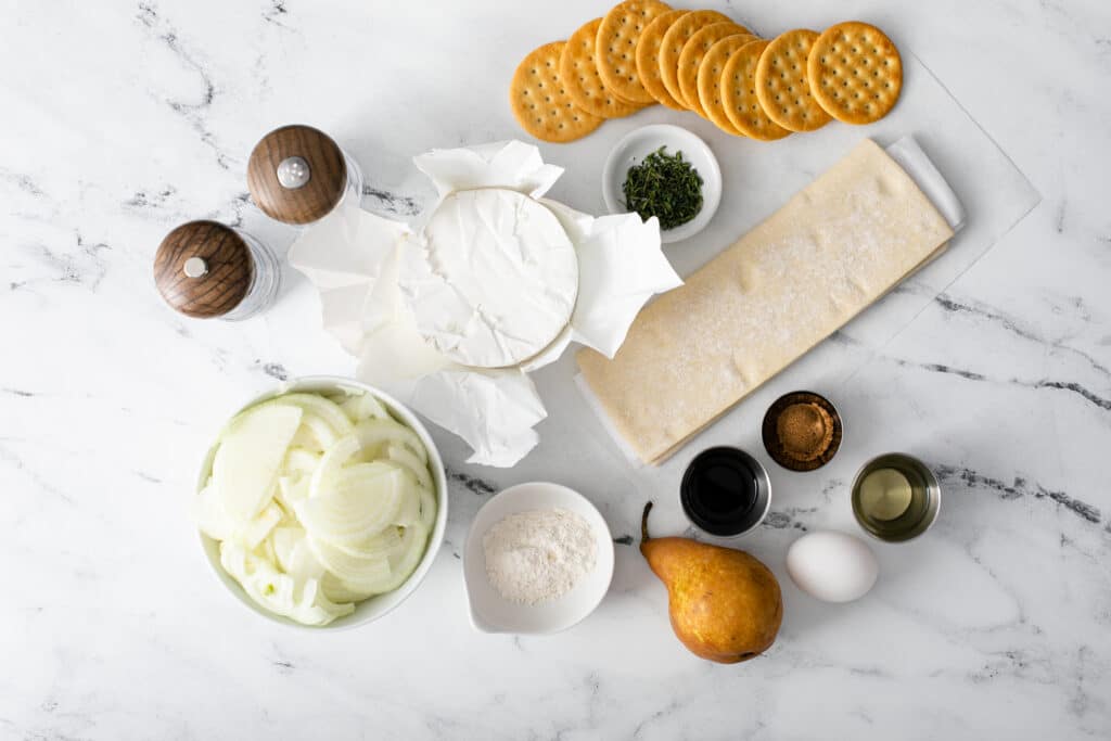 Ingredients of Baked Brie With Balsamic Caramelized Onions flat lay shot