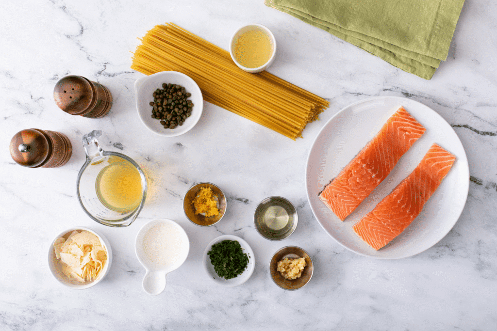 Ingredients for Creamy Lemon Salmon Piccata Pasta flat lay shot