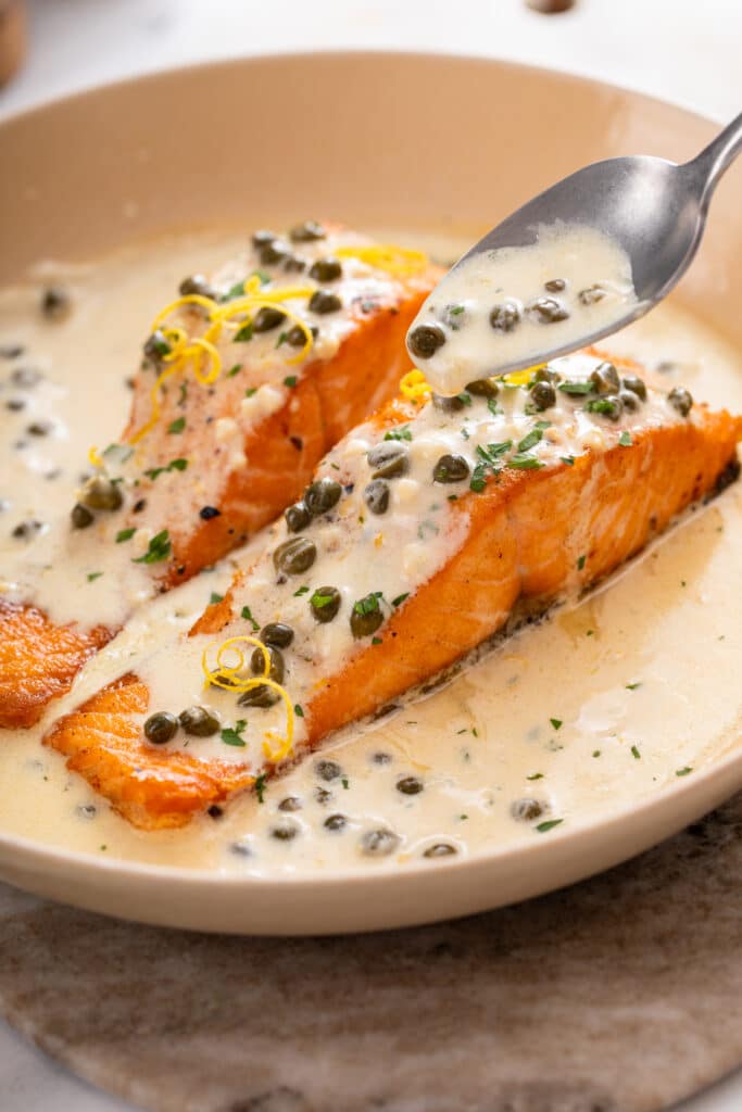 Creamy Lemon Salmon Piccata Pasta close up shot of its white sauce