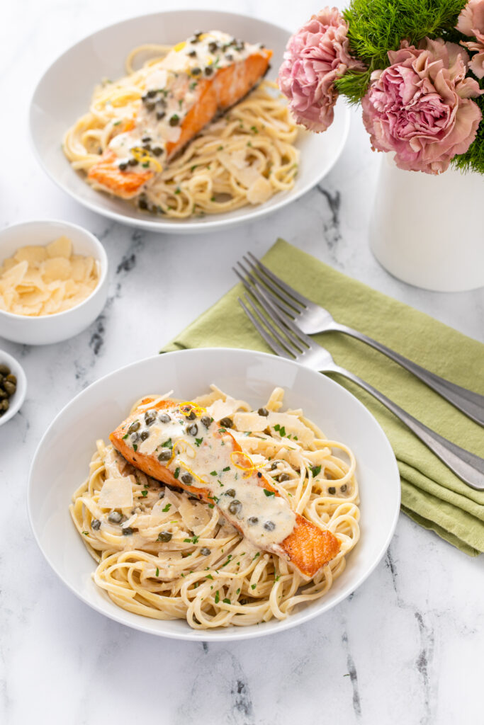 Creamy Lemon Salmon Piccata Pasta served with cheese and capers