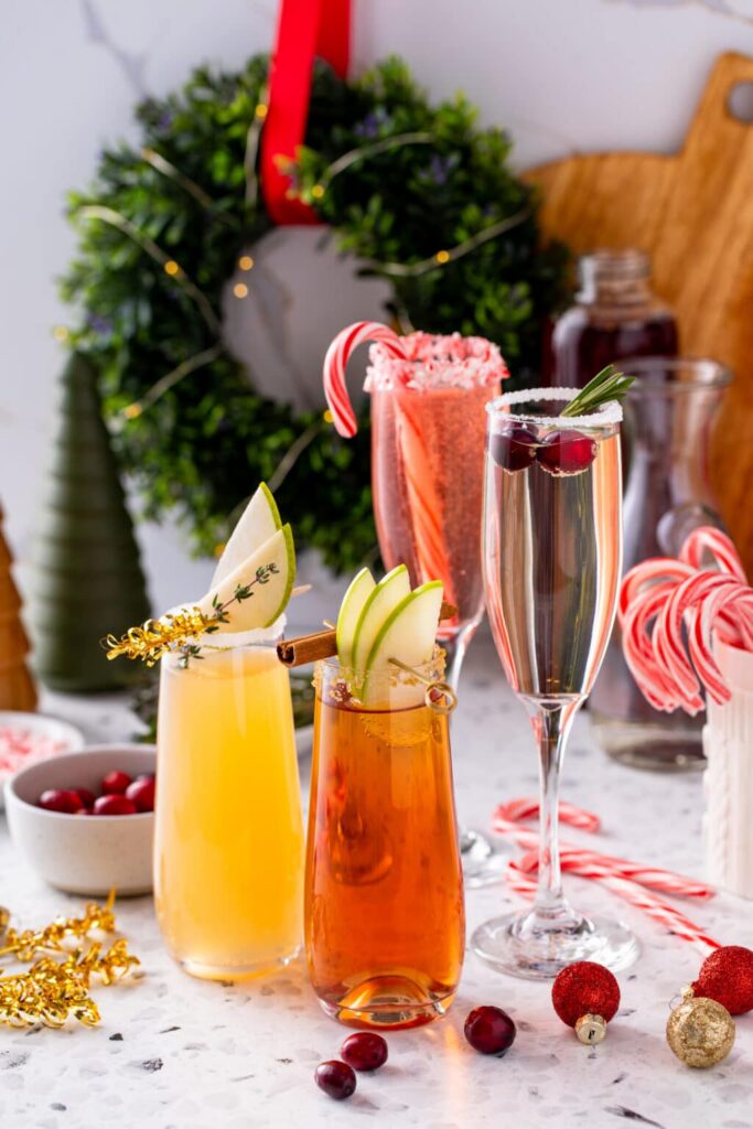4 different mimosas in their serving glasses for How to set up a Holiday Mimosa Bar 