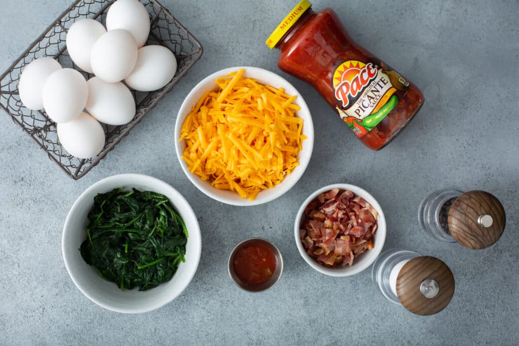 Ingredients for Bacon Spinach & Cheese Egg Muffins flat lay shot