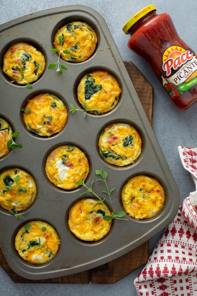 With cheese and newly baked Bacon Spinach & Cheese Egg Muffins