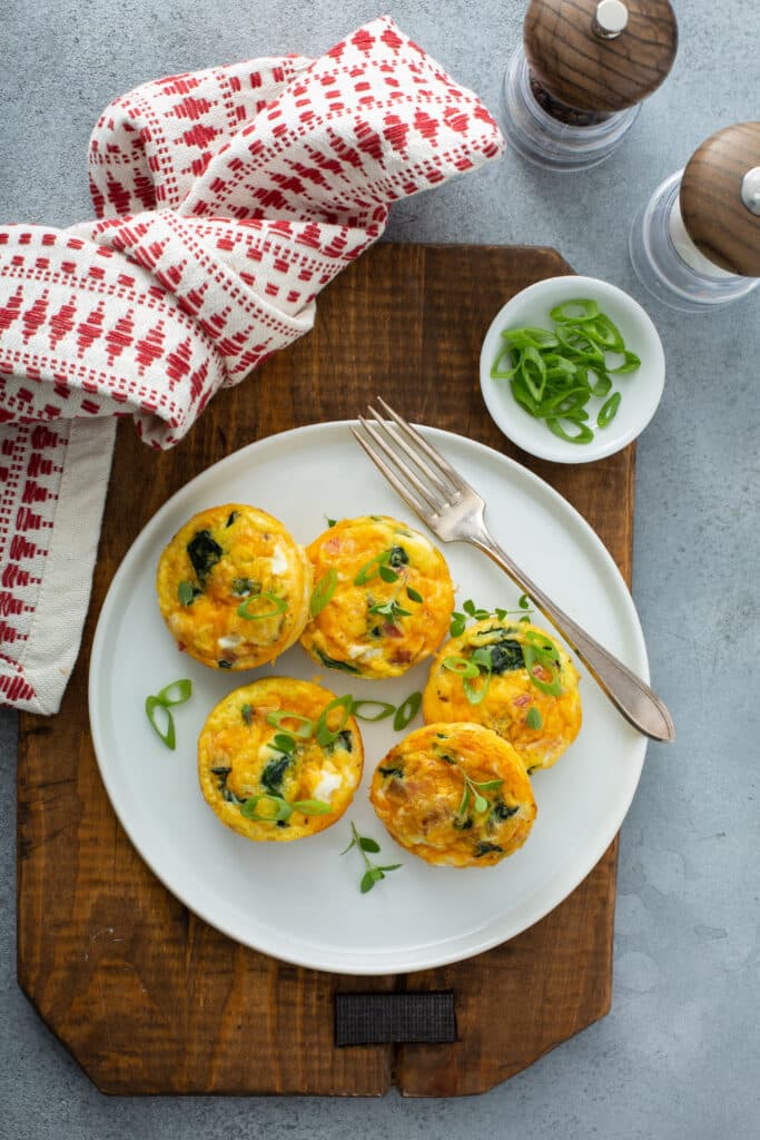 Bacon Spinach & Cheese Egg Muffins served in white platter