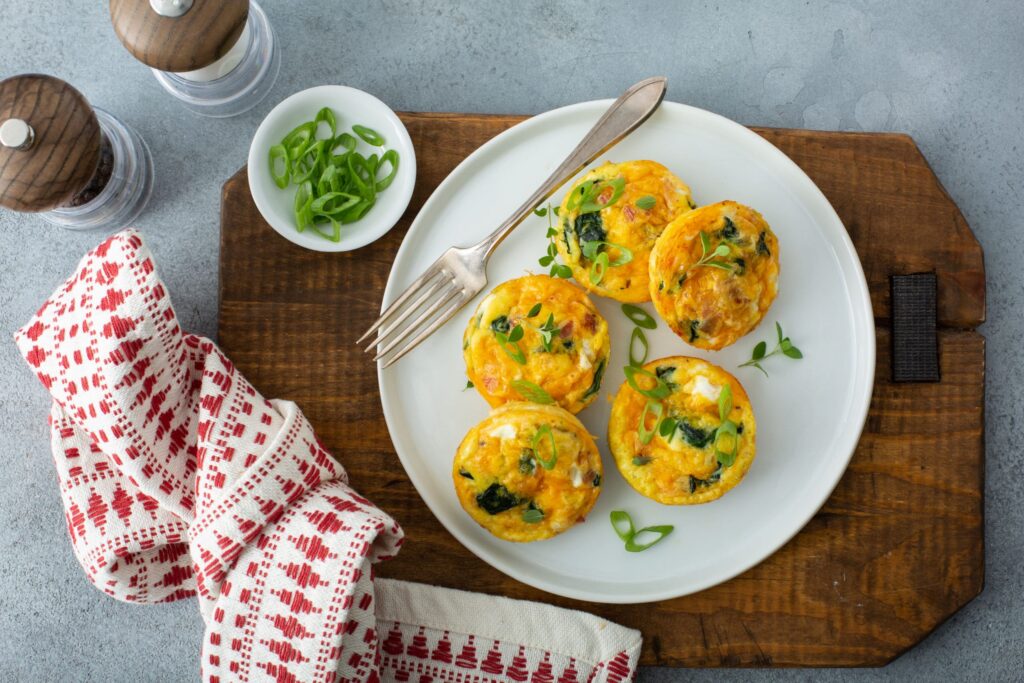 Bacon Spinach & Cheese Egg Muffins served in white platter