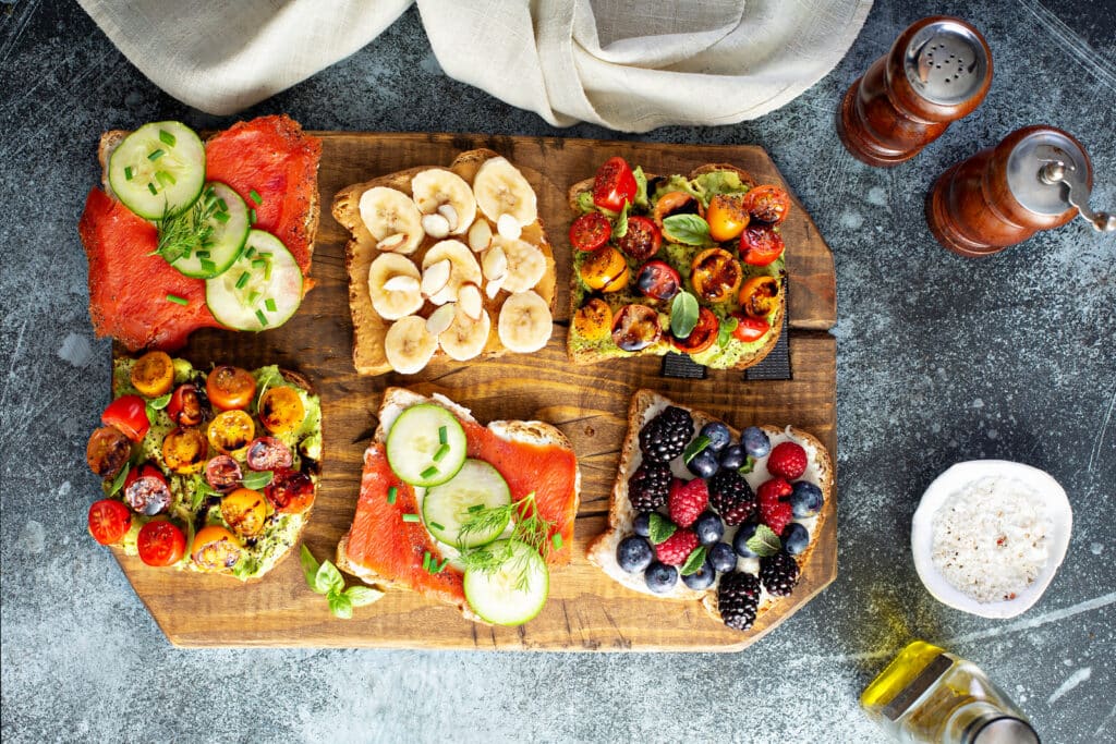 Almond Butter Banana Toast different toast variants served in wooden plate