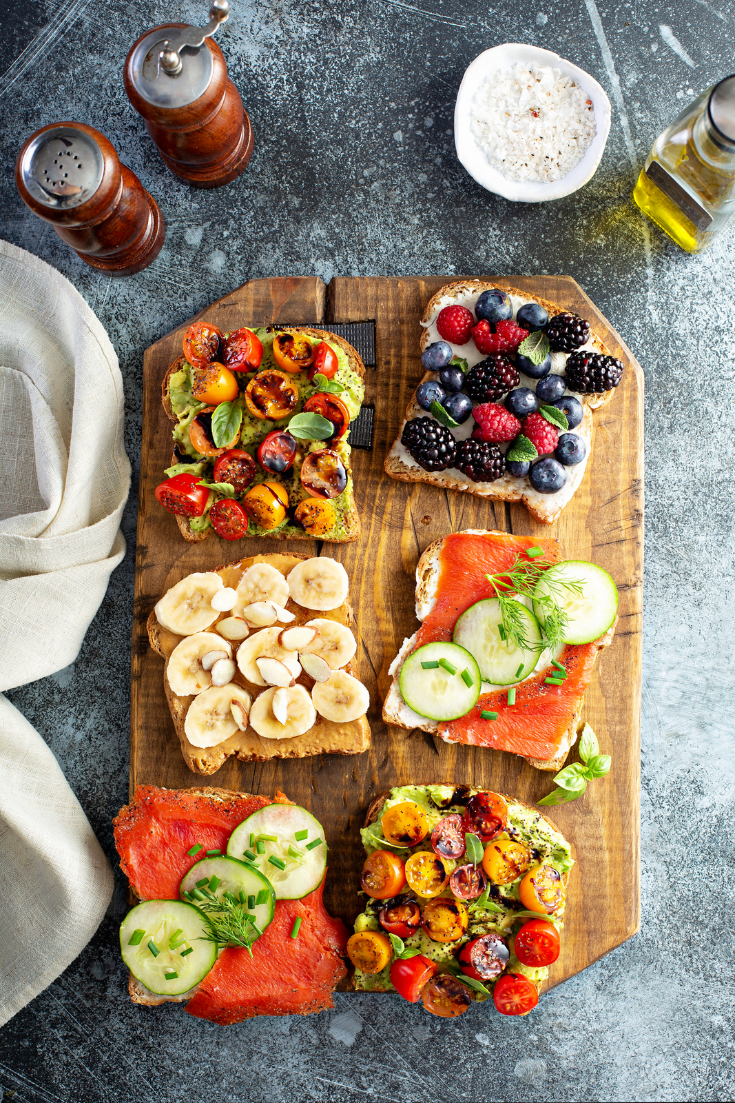 Almond Butter Banana Toast different toast variants served in wooden plate