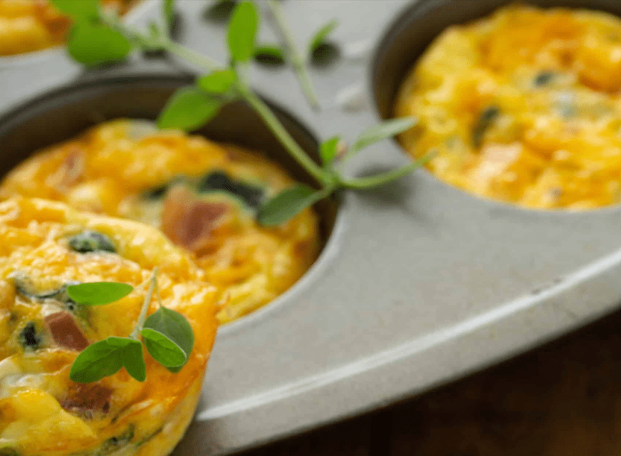 preparing the muffin pan for Bacon Spinach & Cheese Egg Muffins
