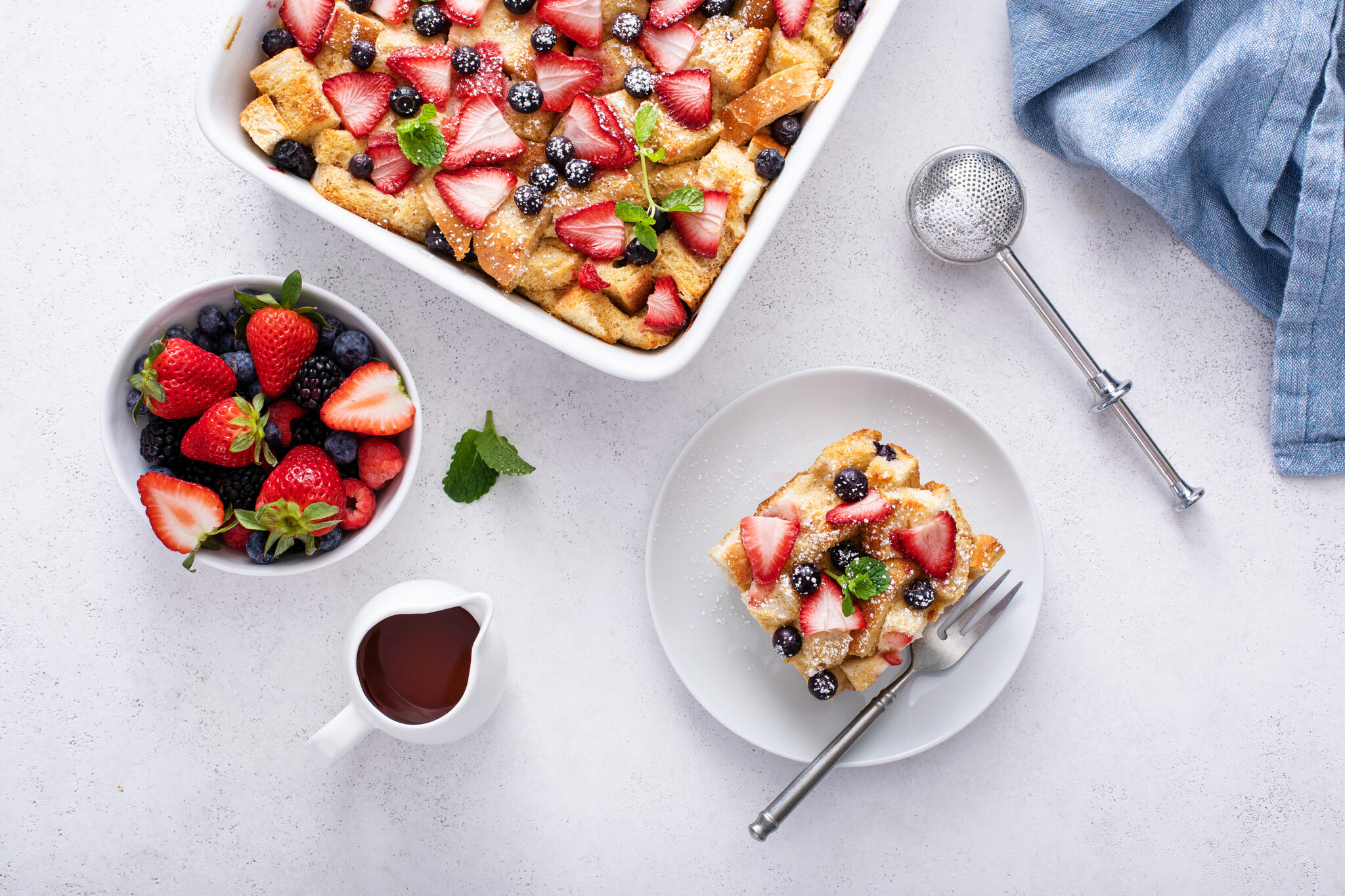 Very Berry French Toast Casserole served from the baking dish topped with powder sugar