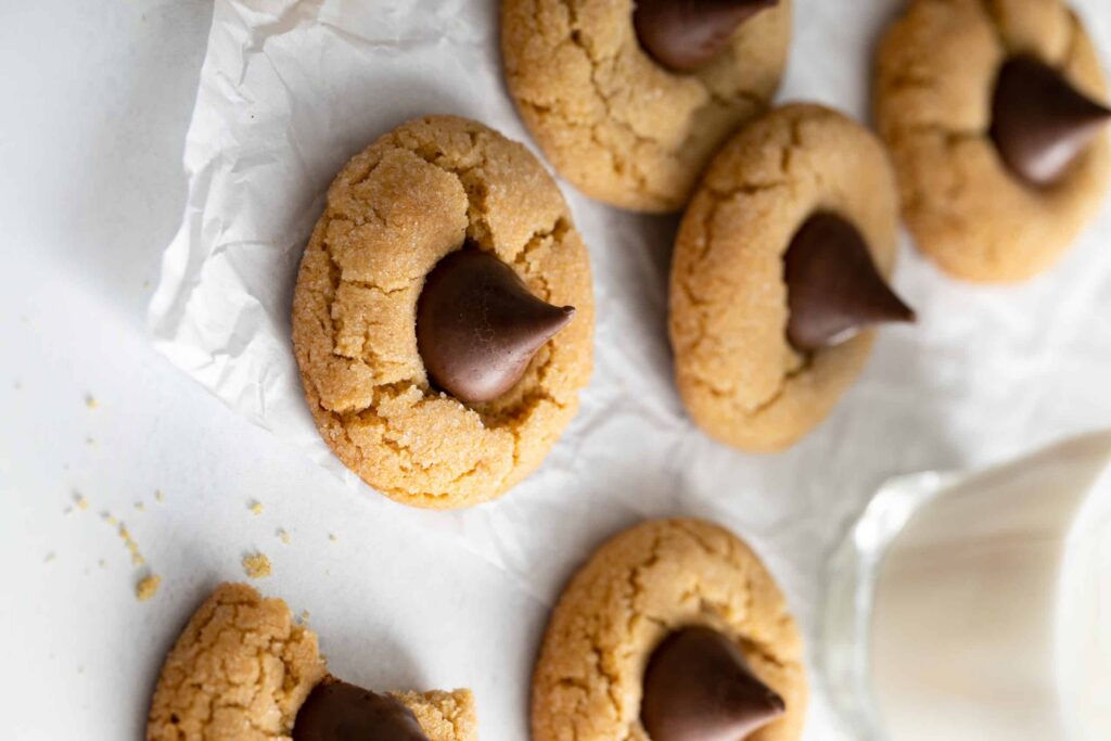 Close up shot of Peanut Butter Blossoms with chocolate kisses toppings