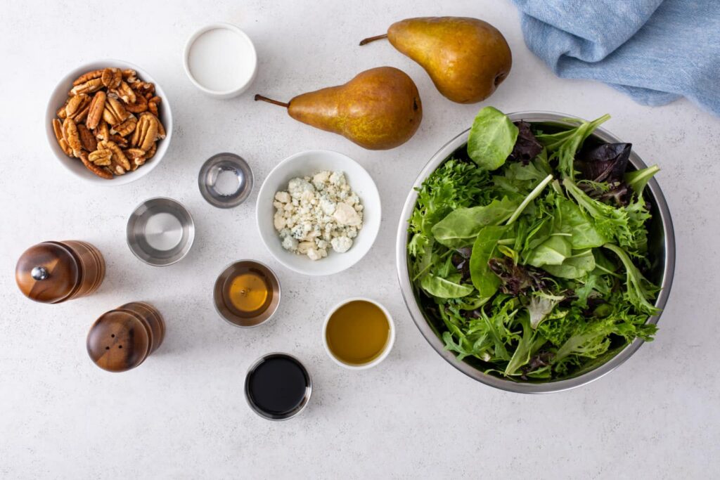 Ingredients for Pear & Gorgonzola Salad with Candied Pecans flat lay shot