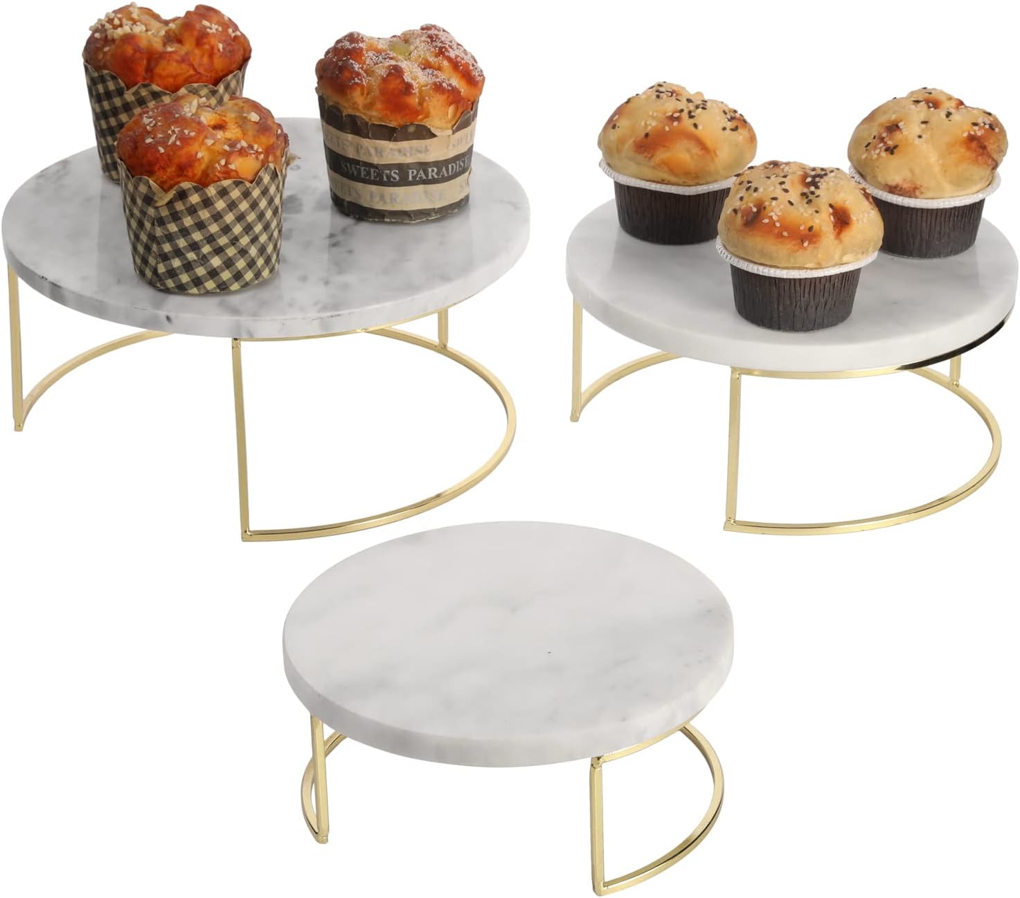 Set of three white marble cake stands with brass bases for adding height to a bar