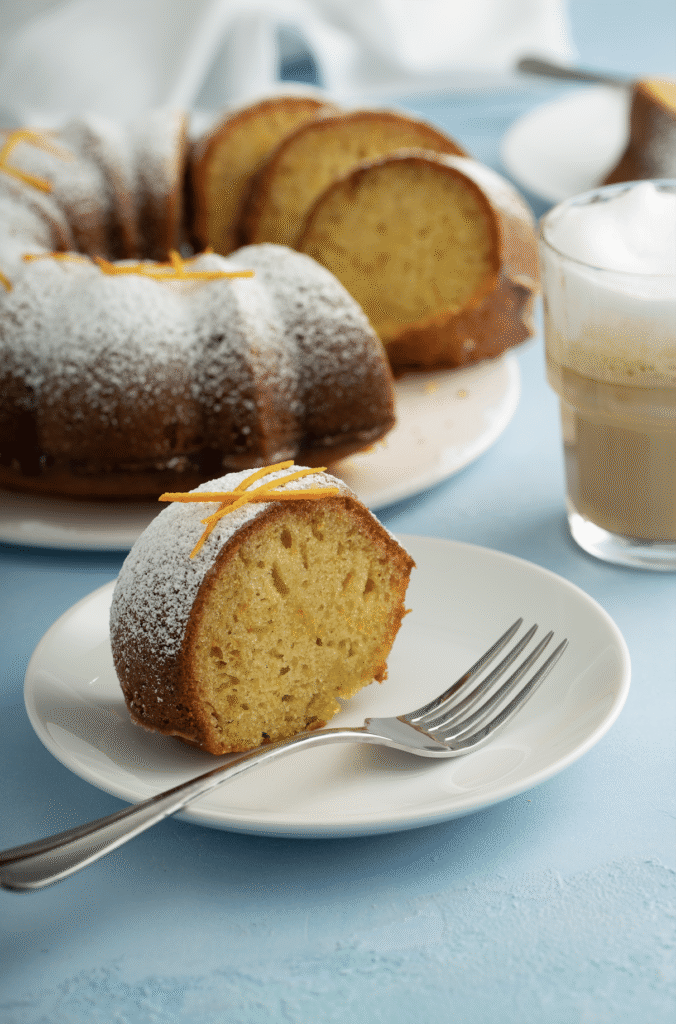 sliced Orange-Scented Olive Oil Bundt Cake close up shot served with iced coffee